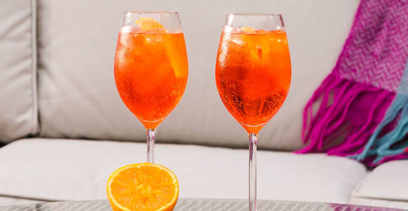 2 aperol spritz drinks served on a garden table