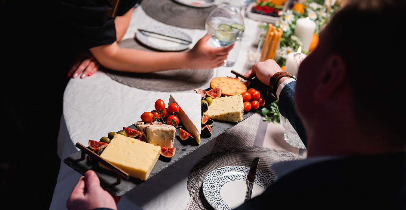 Cheese board being handed round at a dinner party