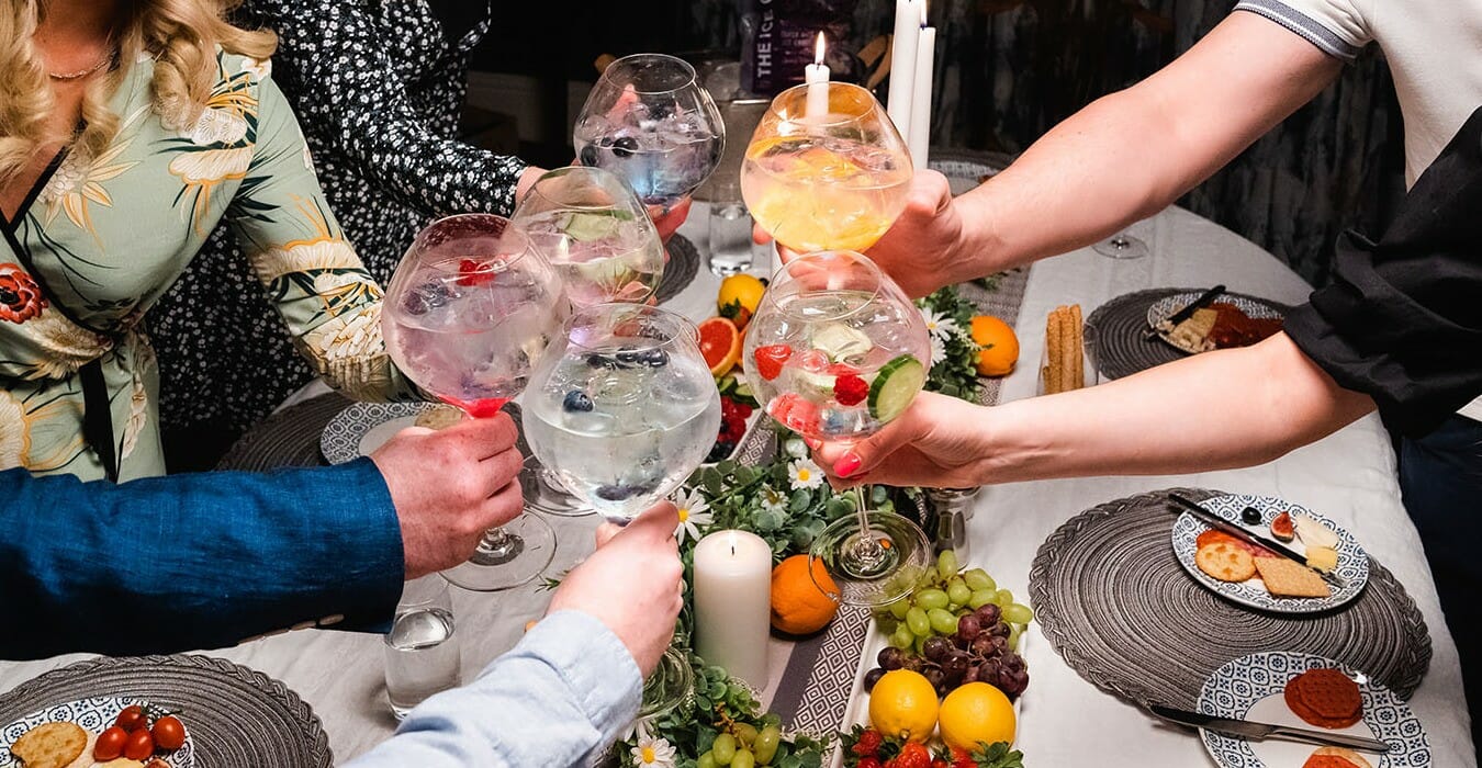 6 gins cheering over a dinner party table