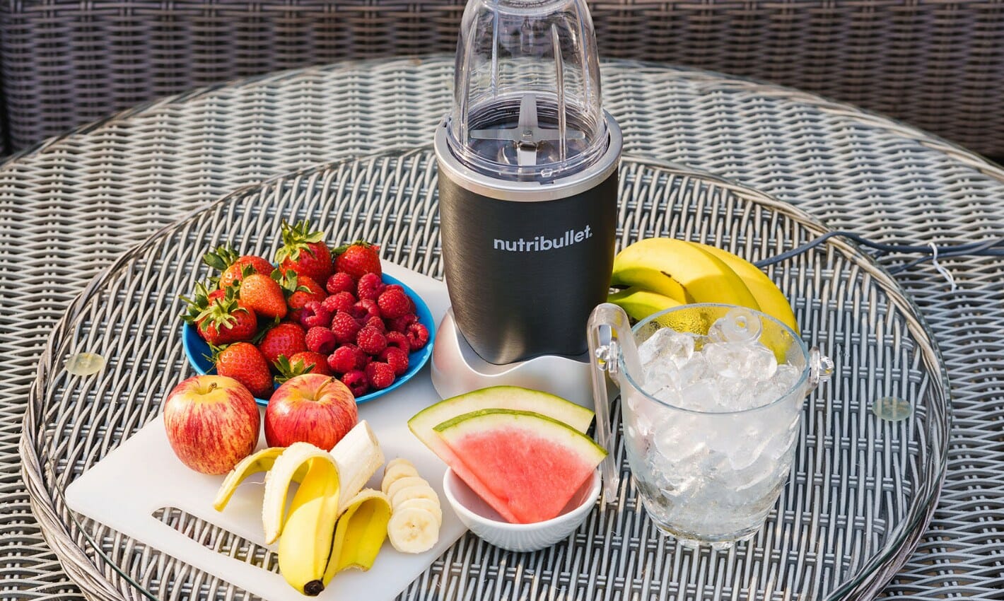 Picture of a Nutribullet with fruit surrounding it