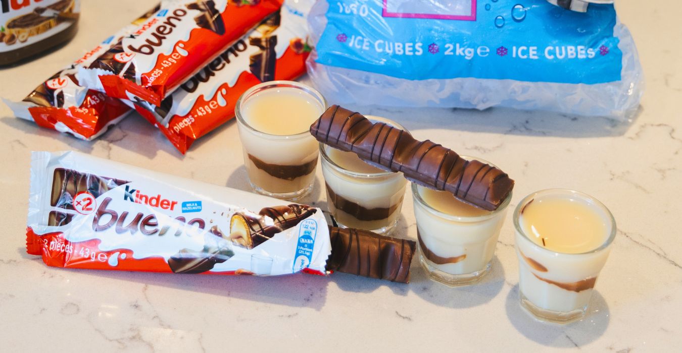 Kinder bueno shot party recipe surrounded by kinder bueno chocolate bars
