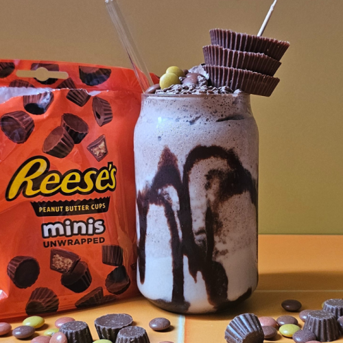Reese's Peanut Butter Milkshake surrounded by Reese's Pieces