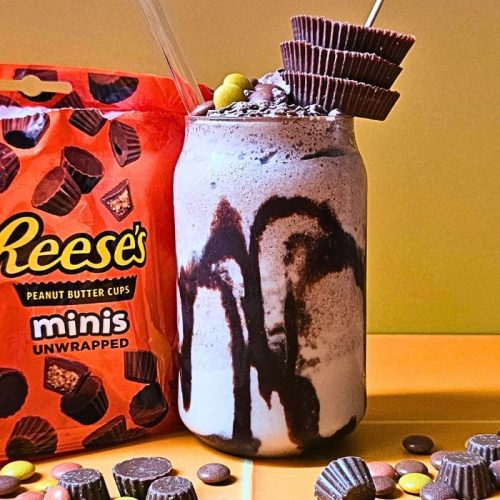 Reese's Peanut Butter Milkshake surrounded by Reese's Pieces