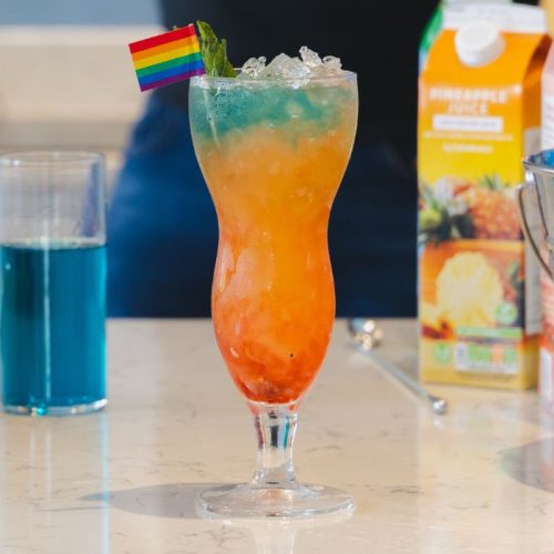 Tiki pride cocktail with colourful cocktails in glasses and an ice bucket