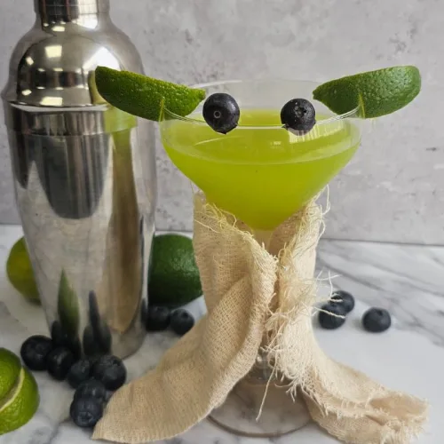 Star Wars Day Baby Yoda Cocktail, Green cocktail with lime ears and blueberry eyes