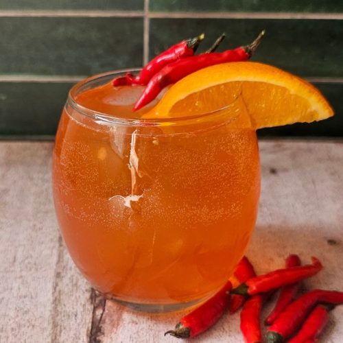 Hot Honey Aperol Spritz Surrounded by Chillis