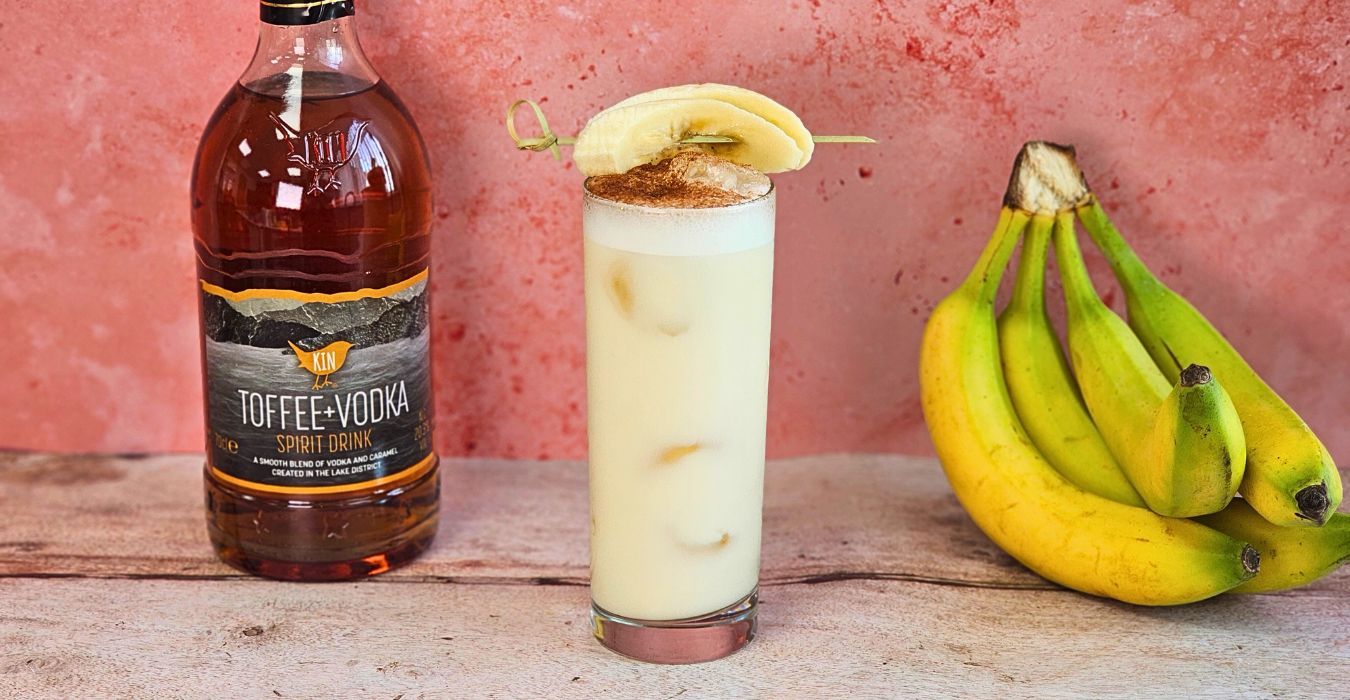 kins banoffee bliss coktail next to bannanas and a bottle of kin vodka