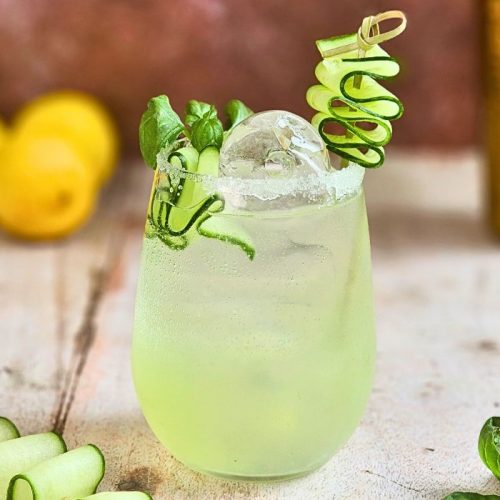 cucumber basil gin smash cocktail with fresh cucumber and herbs