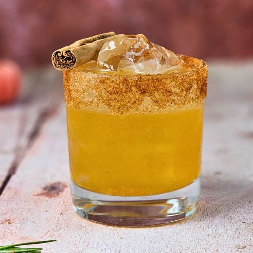 Autumn Old Fashioned cocktail with sugar and cinnamon rim and a cinnamon stick garnish