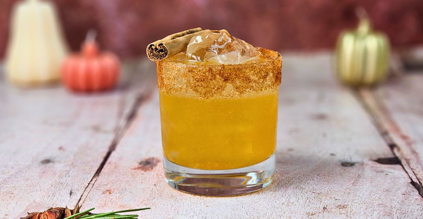 Autumn Old Fashioned cocktail with sugar and cinnamon rim and a cinnamon stick garnish