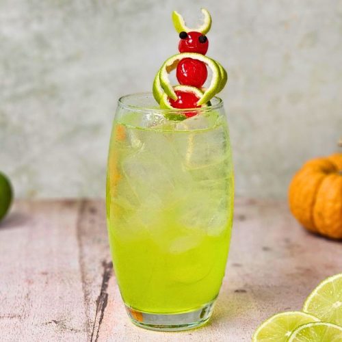 electric tokyo tea cocktail with small pumpkins and sliced lime